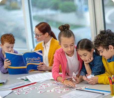 Teacher helping young children with a classroom learning activity.